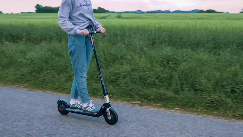 girl from eridehero riding the unagi model one e500 electric scooter in blue
