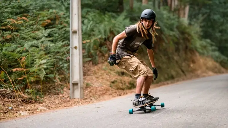 Man pumping his longboard downhill