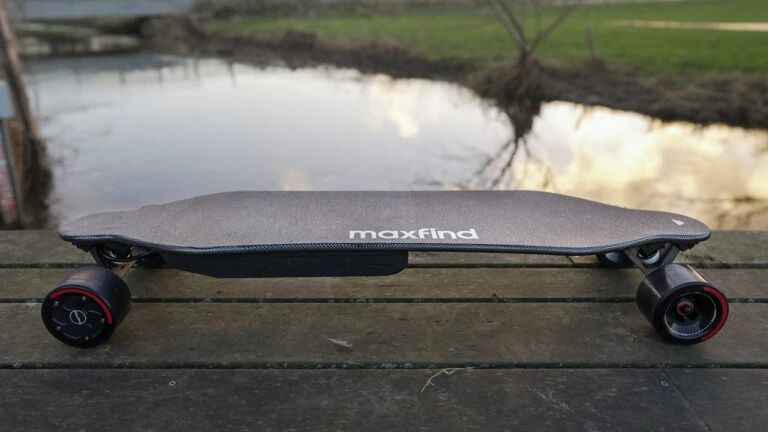 Maxfind Max4 Pro electric skateboard with a landscape background